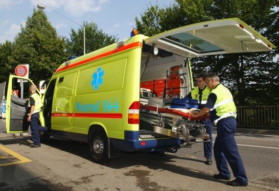 Paramedics transferring a patient to the ambulance