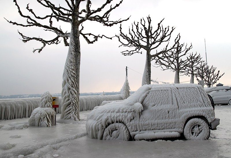 Picture shows iced car and street.